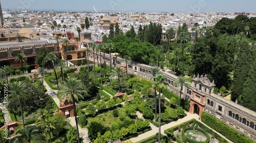 Aerial view from a drone of beautiful old Royal Alcázar of Seville with garden in Seville, Spain in sunny summer weather