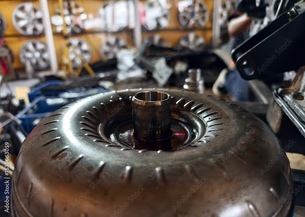 A car engine is being worked on inside a garage workshop A car engine is being worked on inside a garage workshop