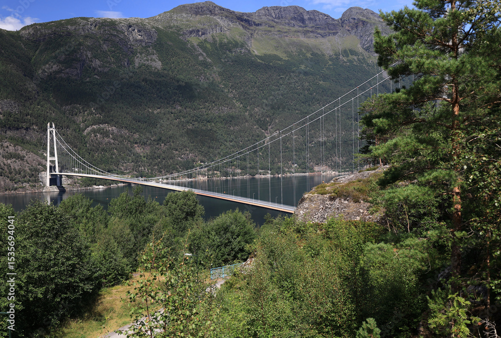 Fototapeta premium Landscape photo with a view of Hardangerbrua bridge and mountains in the background near the city of Bergen in Norway