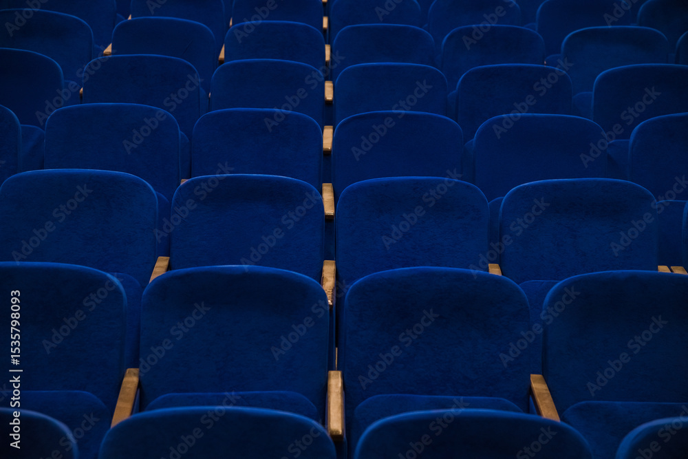 Blue empty seats in the audience prepared for the participants of the conference or presentation Blue empty seats in the audience prepared for the participants of the conference or presentation