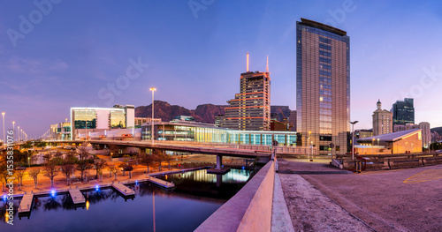 Panorama: Cape Town city lights reflecting on canal at CTICC after sunset, South Africa