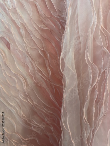 Delicate sheer pink ruffle fabric with soft texture