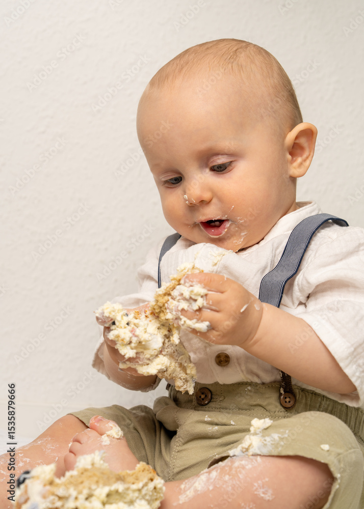 Baby boy with frosting-covered hands and face enjoying his first birthday cake. Messy, fun, and heartwarming moment great for parenting, celebration, and childhood themes. Baby boy with frosting-covered hands and face enjoying his first birthday cake. Messy, fun, and heartwarming moment great for parenting, celebration, and childhood themes.