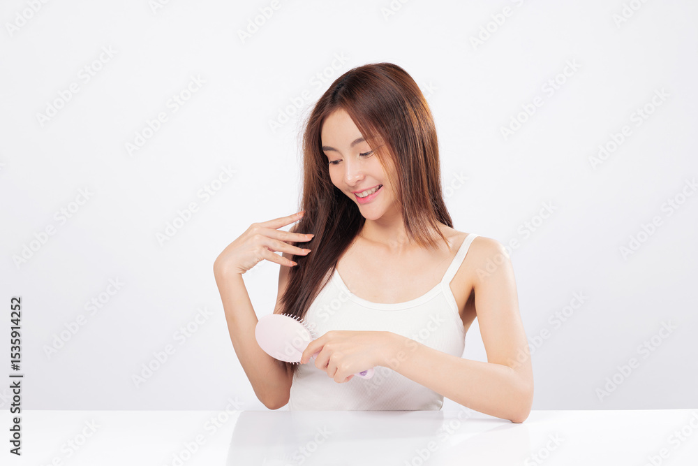 Hair brushing and tangle-free hair are captured as a smiling woman maintains her look, expressing confidence and the importance of daily hair care routines. isolated studio white background Hair brushing and tangle-free hair are captured as a smiling woman maintains her look, expressing confidence and the importance of daily hair care routines. isolated studio white background