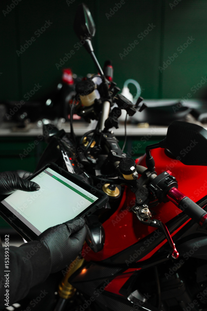 Mechanic performing system diagnostics via tablet. Motorcycle system diagnostic, scanning for faults across engine, electrical, and sensor modules to ensure reliability. Mechanic performing system diagnostics via tablet. Motorcycle system diagnostic, scanning for faults across engine, electrical, and sensor modules to ensure reliability.