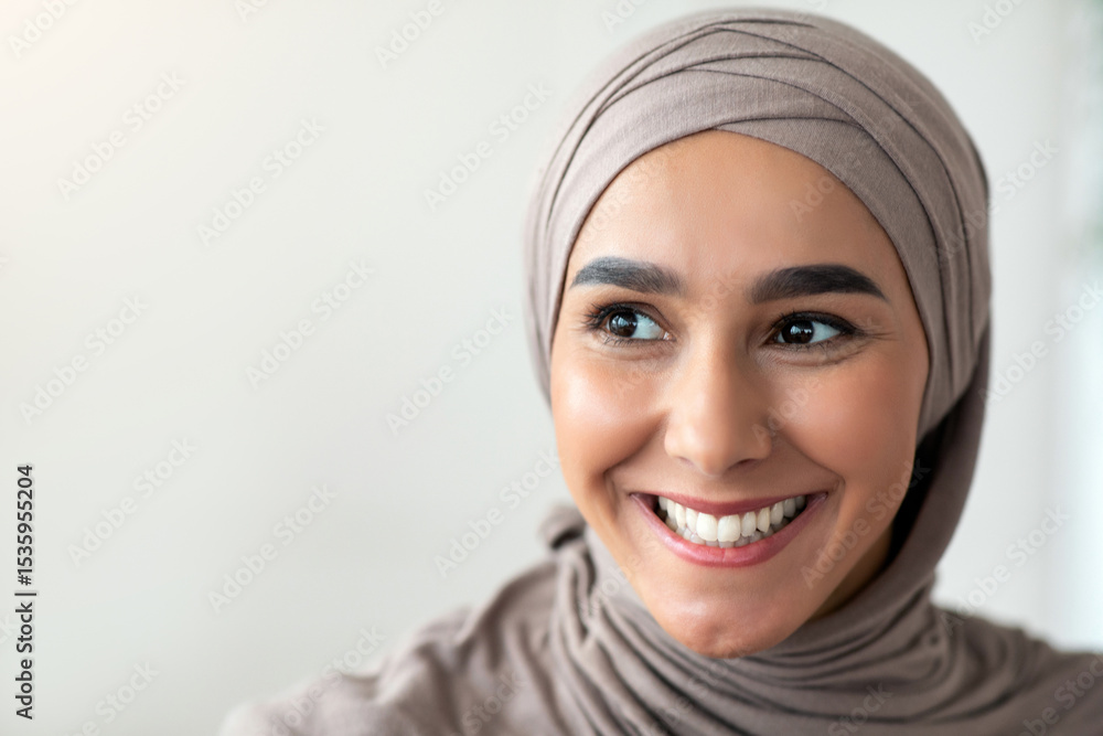 Closeup portrait of cheerful muslim lady in stylish headscarf looking at copy space, panorama. Happy arab woman in hijab watching advertisement and smiling. Job opportunities for arab women Closeup portrait of cheerful muslim lady in stylish headscarf looking at copy space, panorama. Happy arab woman in hijab watching advertisement and smiling. Job opportunities for arab women