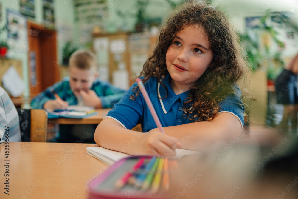 Elementary school student girl learning and thinking in classroom Elementary school student girl learning and thinking in classroom