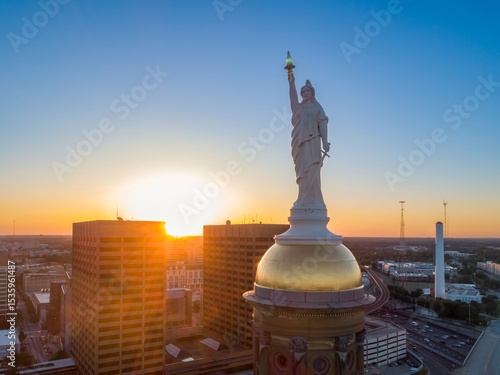 Goddess of Liberty statue atop the Georgia State Capitol dome in Atlanta, USA at sunset. Iconic landmark representing liberty.
