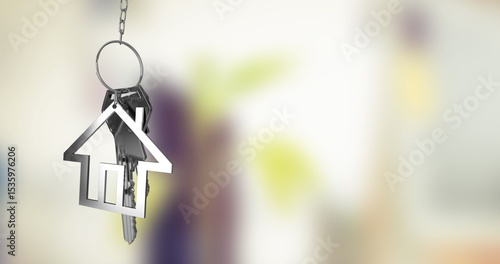 Photography Hanging metallic house-shaped keychain pendant dangling from chain in entryway,