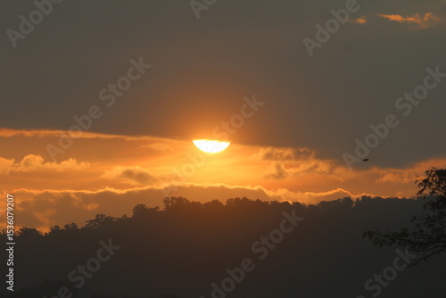 the sun setting among the clouds makes the sky look beautiful