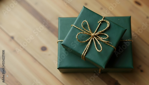 Green Gift Box with String on Wooden Surface