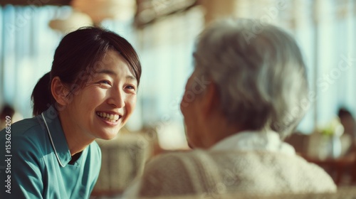 Wallpaper Mural A woman in a blue shirt is smiling at an older woman Torontodigital.ca
