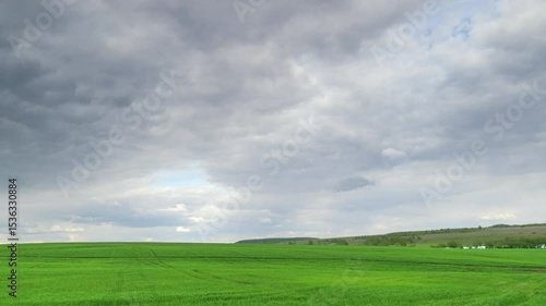 Wallpaper Mural A Serene Green Landscape Awaits Beneath Overcast Cloudy Skies, Perfect for Hiking Time lapse. Torontodigital.ca