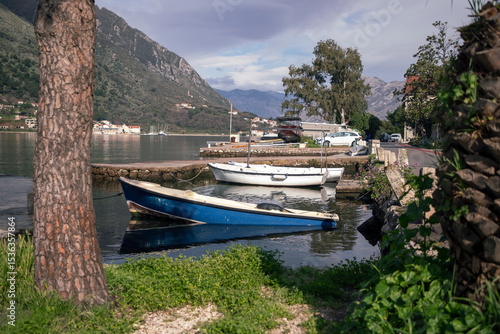 Boats moored along the shore of the Bay of Kotor in the Adriatic Sea, Montenegro