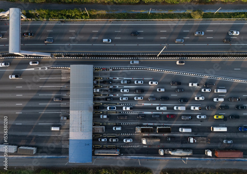 Картината върху платно A highway where cars are paying tolls.