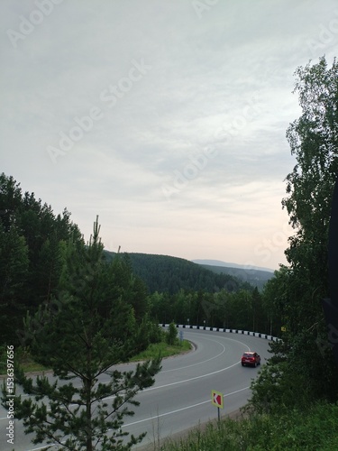 the car on the road goes into the sunset