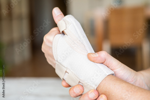 Close-up of a hand wearing an orthopedic brace, providing support and pain relief for conditions like rhizarthrosis, a degenerative joint disease affecting the base of the thumb