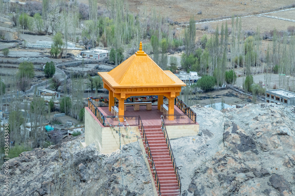 Obraz premium Far view of meditation space at Diskit Monastery with majestic Himalayan mountains in the backdrop. Serene landscape blending spirituality, culture, and nature, ideal for travel and creative projects