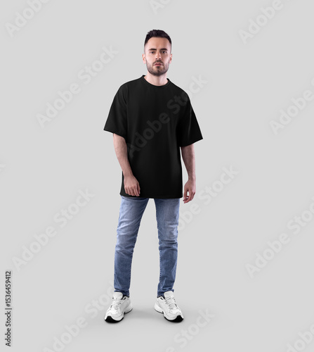 Mockup of black oversized t-shirt on bearded guy in jeans, sneakers, full length front view, isolated on background.