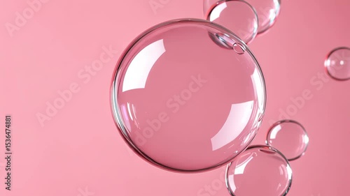 Delicate round transparent bubbles floating gently on soft pink background with shiny and light floating effect