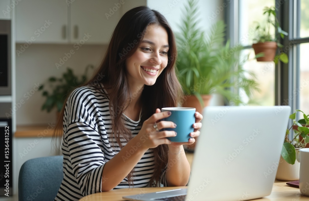 Smiling young woman in kitchen doing video call, holding cup of coffee. Brunette girl cheerful, looking at laptop, enjoying remote communication. Home office, online meeting, cozy vibes. Smiling young woman in kitchen doing video call, holding cup of coffee. Brunette girl cheerful, looking at laptop, enjoying remote communication. Home office, online meeting, cozy vibes.