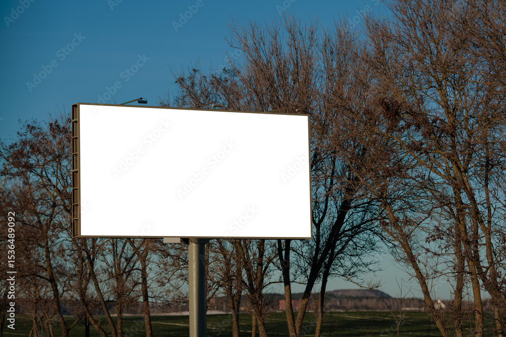 Fototapeta premium White billboard along the highway. Background for design and advertising.