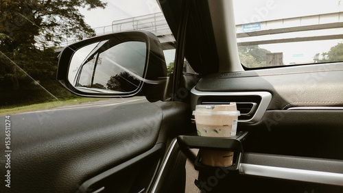 Driving Perspective with Iced Coffee in Car Cupholder and Side Mirror View