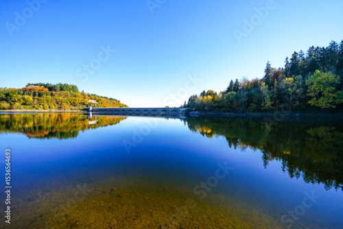 Fototapeta Naklejka Na Ścianę i Meble -  View of the Oleftalsperre Dam and the surrounding landscape. Nature at the lake near the Eifel National Park near Hellenthal in the Hohes Venn-Eifel Nature Park.
