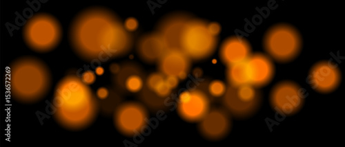 Orange blurred bokeh particles with varying size and opacity on black background. Abstract design element for festive or sci-fi scenes.