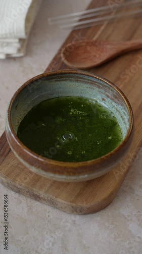 Pouring water over matcha powder for matcha latte 