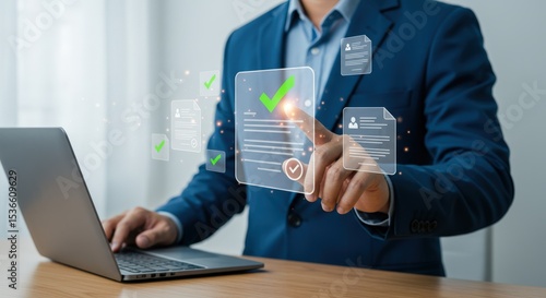 A businessman in a blue suit uses a laptop to review and approve digital documents, each marked with a green checkmark, in a modern office setting