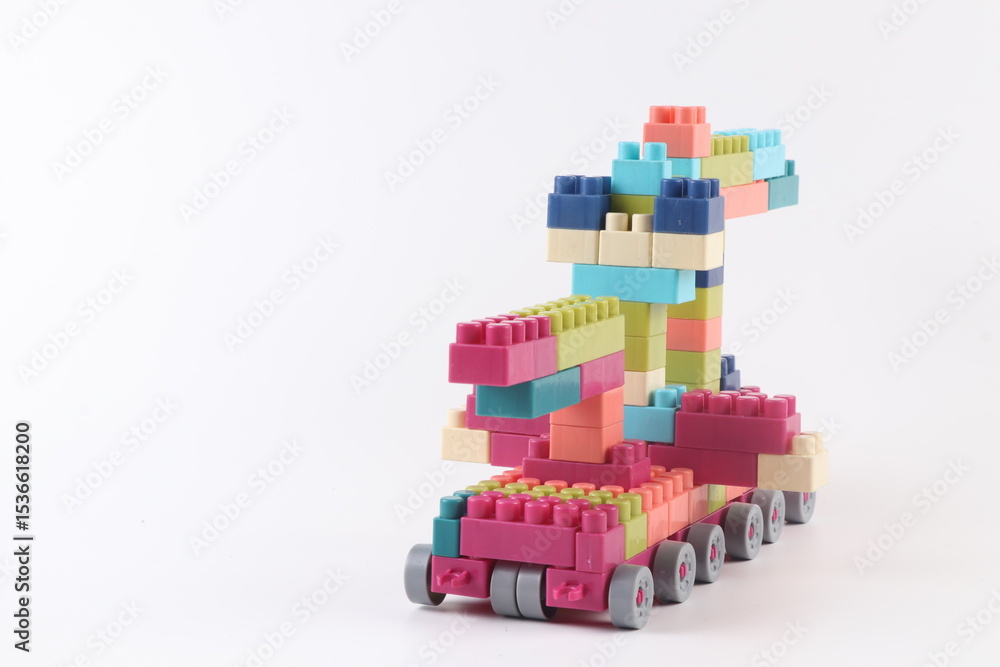 Fototapeta premium Plastic building blocks form vehicle on white background.