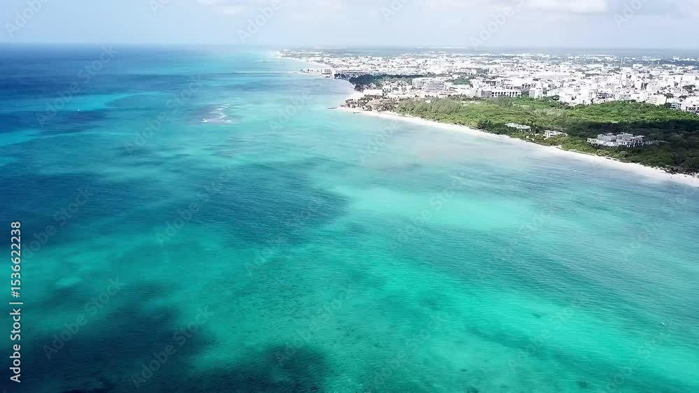 Drone video of the Caribbean Sea and the city of Playa del Carmen from above with turquoise water and white sand beach