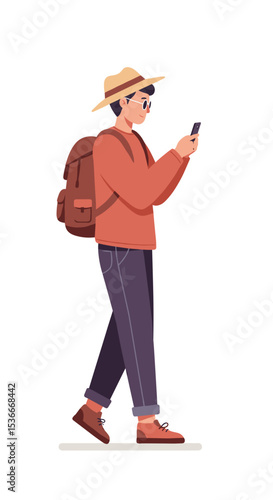 Young man walking and using smartphone while wearing a hat  