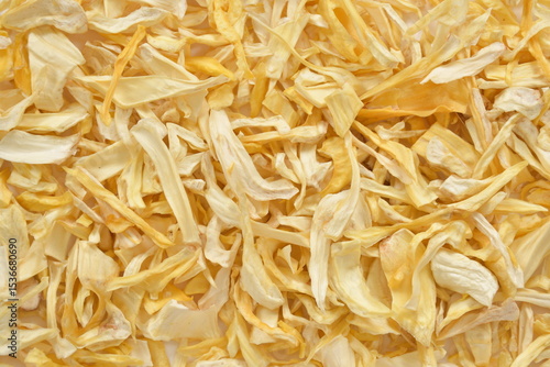 Organic Dried Jackfruit Slices on White Background. High-resolution image of organic dried jackfruit slices in a bowl, with scattered pieces on a clean white background.