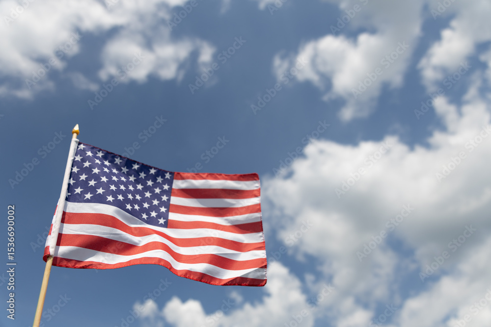Hand holding the American flag for Independence Day - 4th of July. Hand holding the American flag for Independence Day - 4th of July.