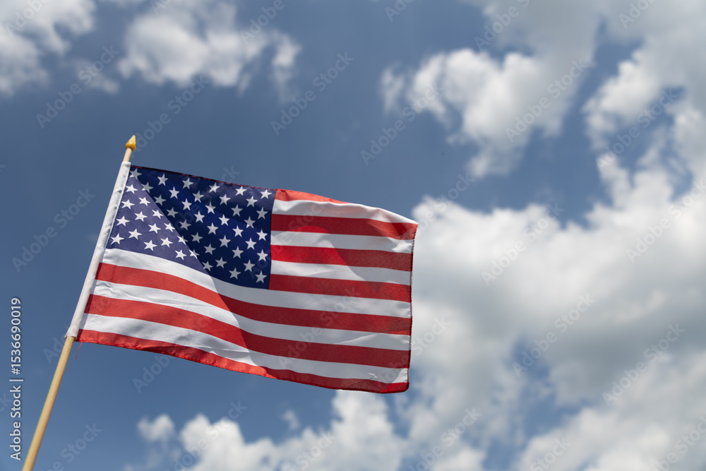 Hand holding the American flag for Independence Day - 4th of July. Hand holding the American flag for Independence Day - 4th of July.