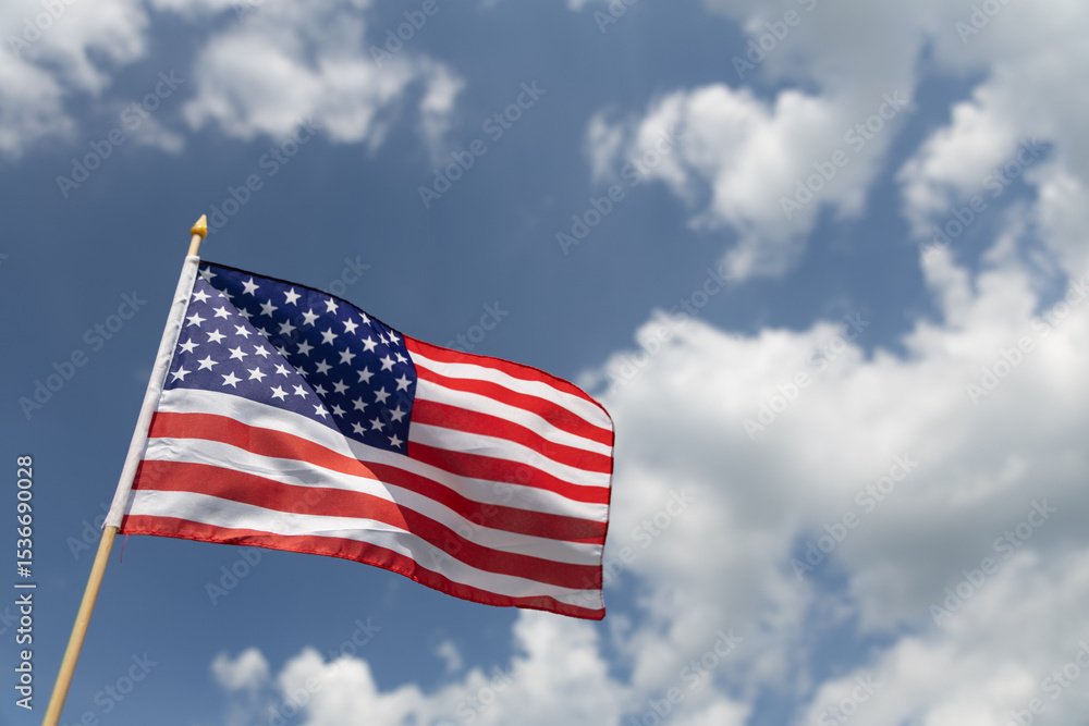 Hand holding the American flag for Independence Day - 4th of July. Hand holding the American flag for Independence Day - 4th of July.