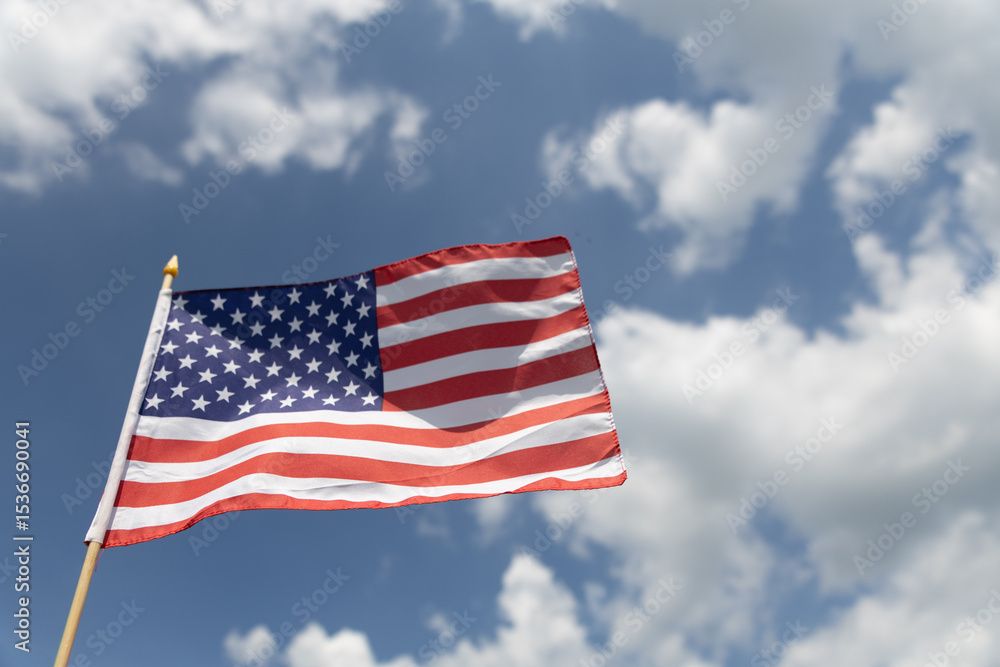 Hand holding the American flag for Independence Day - 4th of July. Hand holding the American flag for Independence Day - 4th of July.