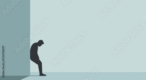 Person sitting against wall feeling dejected