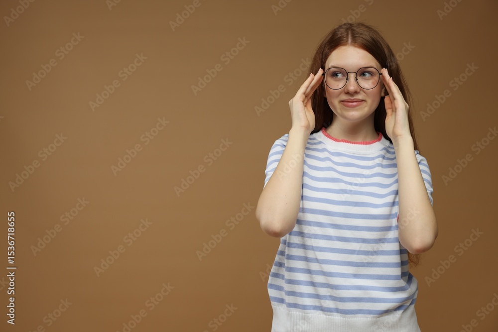 Portrait of teenage girl on brown background. Space for text Portrait of teenage girl on brown background. Space for text
