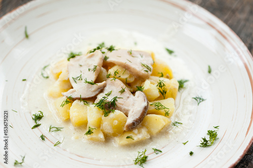 Potatoes with porcini mushrooms and dill on a plate