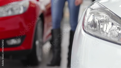 Dynamic car dealership scene showcasing vibrant vehicles and a focused customer
