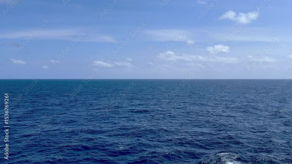 Tranquil open sea view from cruise ship balcony with blue sky and sun Tranquil open sea view from cruise ship balcony with blue sky and sun