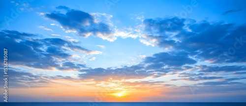 Stunning Sunset over Ocean Horizon with Blue Sky and Clouds
