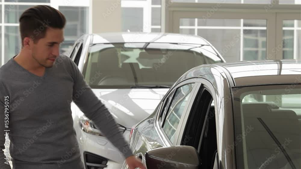 A man inspects the sleek interior of a modern vehicle A man inspects the sleek interior of a modern vehicle