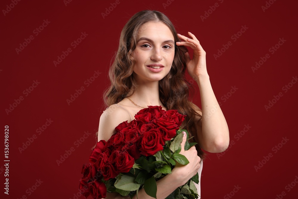 Smiling woman with bouquet of roses on dark red background Smiling woman with bouquet of roses on dark red background