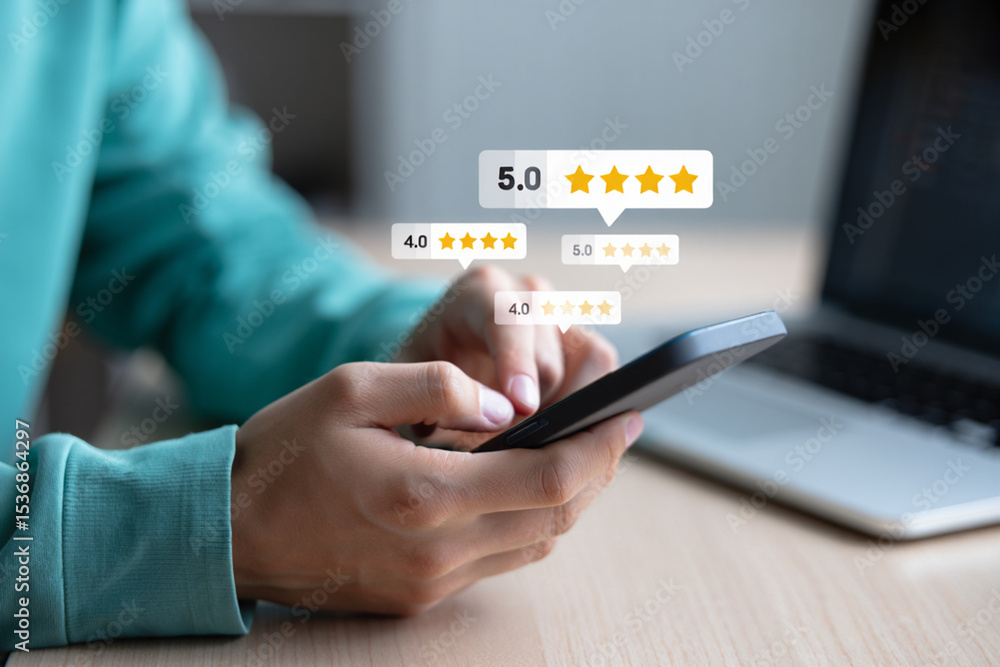 Person using smartphone with five star rating review feedback on screen Person using smartphone with five star rating review feedback on screen