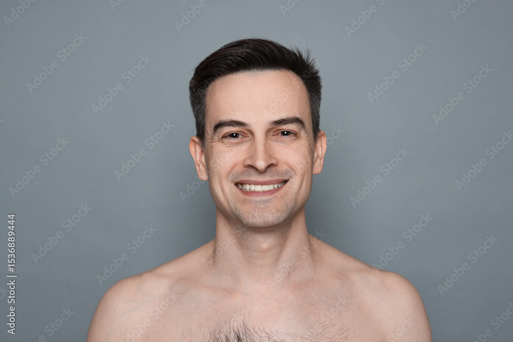 Obraz premium Smiling man after shaving on grey background