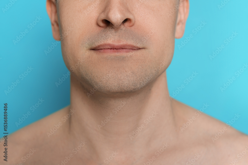 Naklejka premium Man after shaving on light blue background, closeup